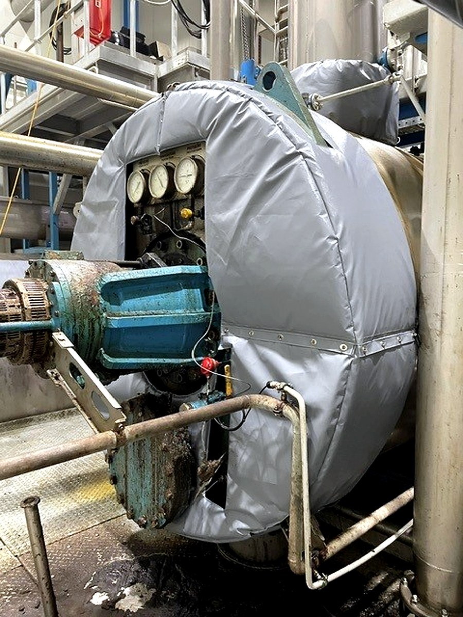 Large custom circular thermal jacket fitted around an industrial pump casing in a process environment